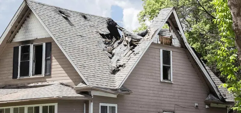 Roof of a house burned and caved in.